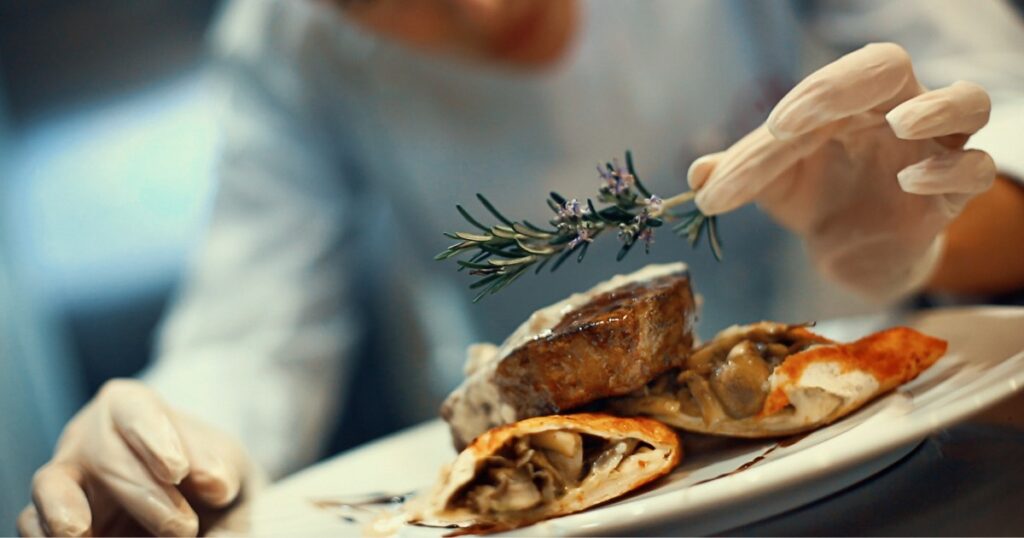 Guide to Catering prices in Calgary - a chef is finalizing a dinner main course