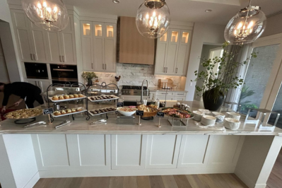 Catering setup for a private party in a Calgary home, with appetizers and hors d'oeuvres elegantly arranged on a modern kitchen island.